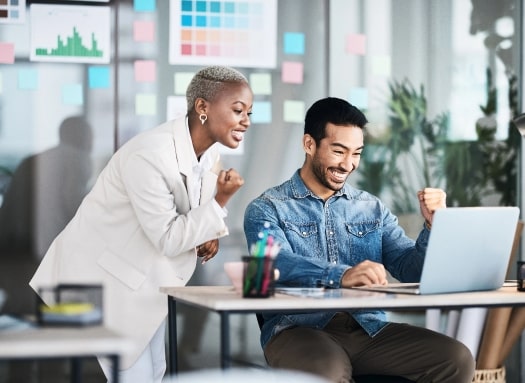 Two coworkers celebrating a good idea