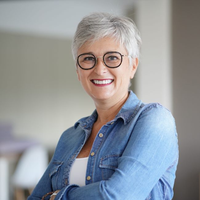 smiling 50 year old woman with white hair